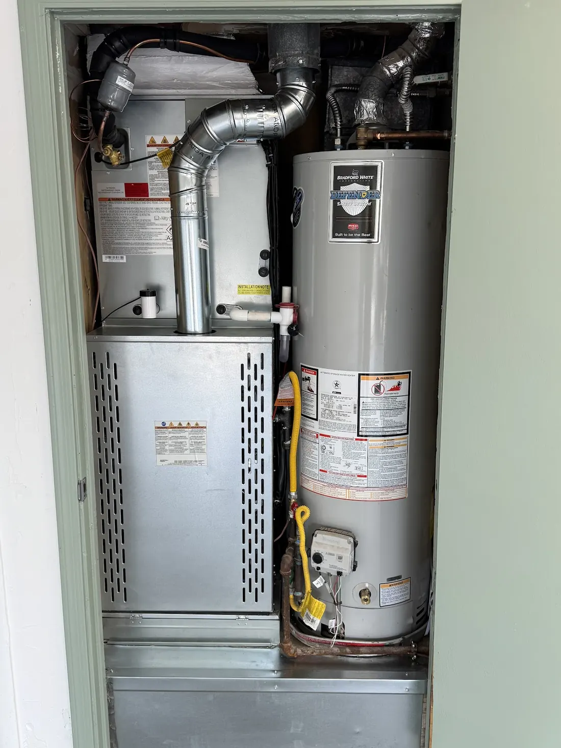 New furnace next to a water heater